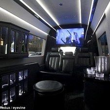 Driving commuters around the Benz: New York City's wealthiest enjoy hidden luxury in Mercedes vans that take up half the