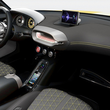 The interior is minimalist with black leather seats with yellow accents.